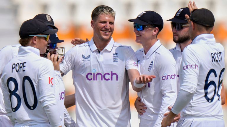 England's Brydon Carse, center, celebrates with teammates after taking the wicket of Pakistan's Naseem Shah during the second day of the first test cricket match between Pakistan and England, in Multan, Pakistan, Tuesday, Oct. 8, 2024. (AP Photo/Anjum Naveed)