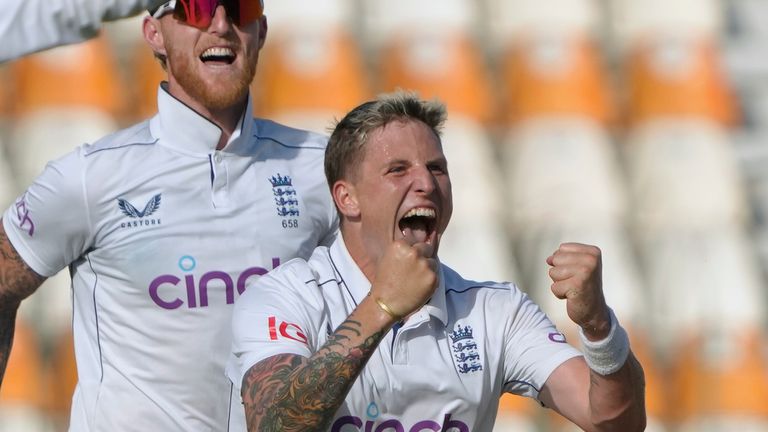 England's Bryden Carrs (front row) takes the ball against Pakistan during the first day of the second cricket test match between Pakistan and England in Multan, Pakistan, Tuesday, October 15, 2024 ·Celebrating with teammates after Shakir's wicket.