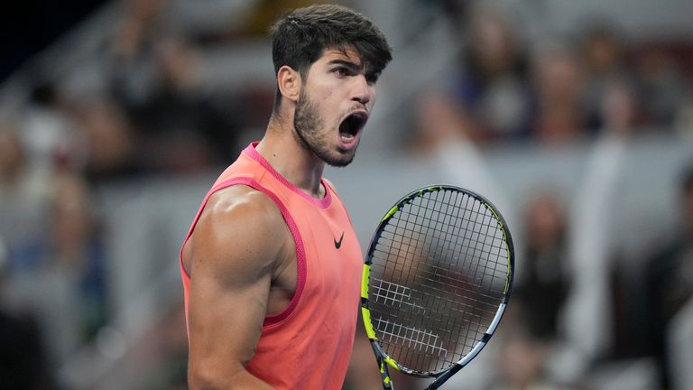 Carlos Alcaraz of Spain reacts during their men's singles finals match against Jannik Sinner of Italy at the China Open tennis tournament, National Tennis Center in Beijing, Wednesday, Oct. 2, 2024. (AP Photo/Achmad Ibrahim)