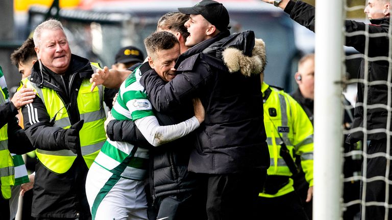 Celtic's Callum McGregor celebrates their late win with a fan