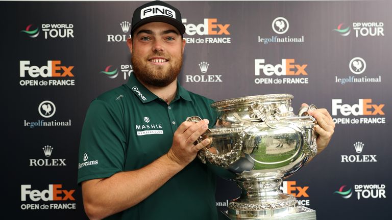 Dan Bradbury of England celebrates winning with the trophy at the FedEx Open de France 2024 at Le Golf National