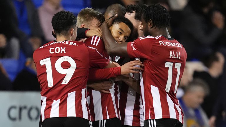 Exeter City's Kamari Doyle (centre) is mobbed by team-mates after scoring their side's first goal