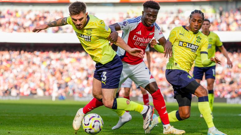 Arsenal's Bukayo Saka (centre) is challenged by Southampton's Ryan Manning (left) and Southampton's Kyle Walker-Peters