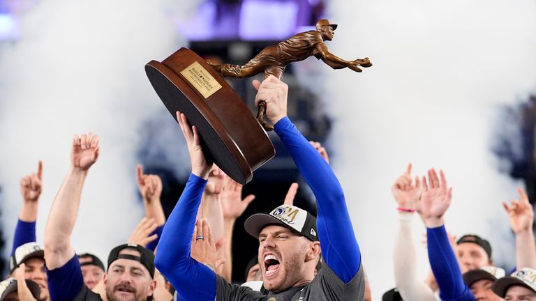 Los Angeles Dodgers' Freddie Freeman celebrates with the MVP trophy after their win against the New York Yankees in Game 5 to win the baseball World Series, Thursday, Oct. 31, 2024, in New York. (AP Photo/Ashley Landis)