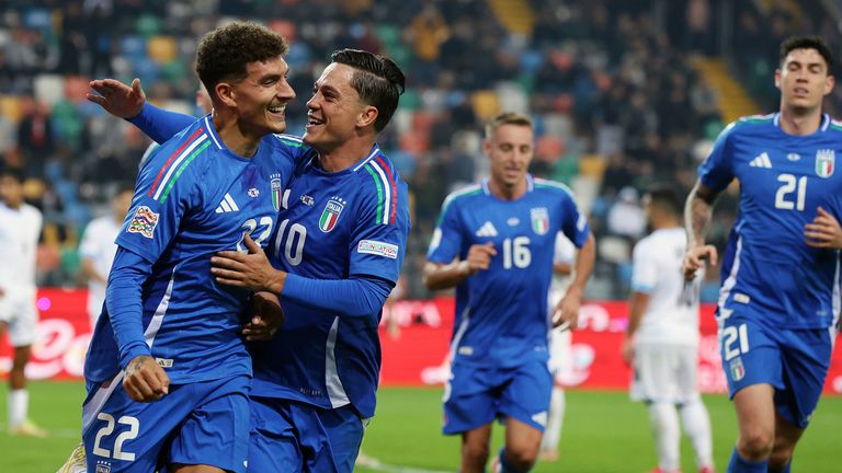 Giovanni Di Lorenzo (left) celebrates after scoring for Italy