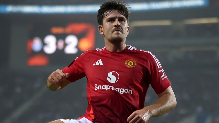 Harry Maguire celebrates his injury-time equalizer for Manchester United against Porto