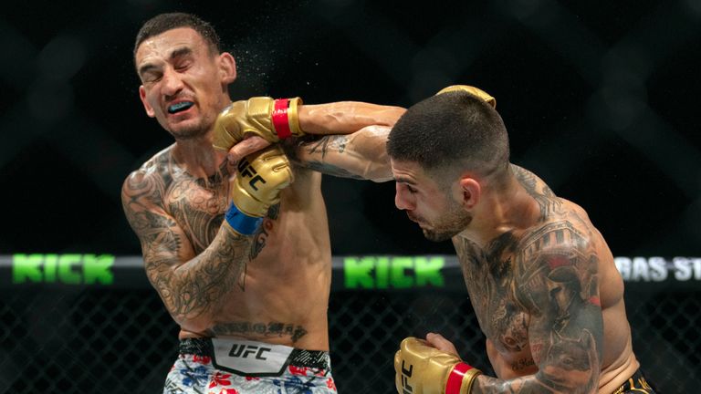 Champion Ilia Topuria (right) battles Max Holloway during their mixed martial arts featherweight title bout at UFC Fight Night in Abu Dhabi