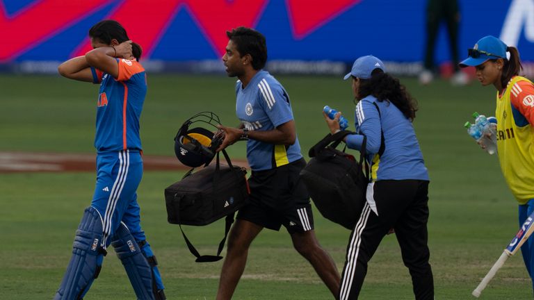 India's captain Harmanpreet Kaur, left, walks back after she hurt herself while batting during the ICC Women's T20 World Cup 2024 match between Pakistan and India at Dubai International Stadium, United Arab Emirates, Sunday, Oct. 6, 2024. (AP Photo/Altaf Qadri)