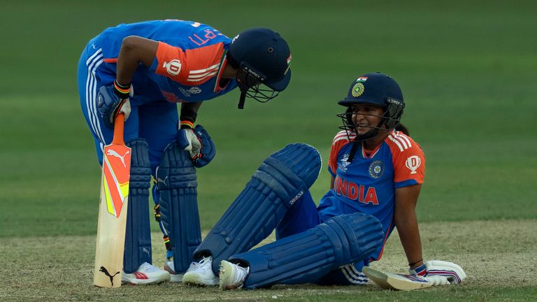 India's captain Harmanpreet Kaur sits on the pitch after she hurt herself while batting during the ICC Women's T20 World Cup 2024 match between Pakistan and India at Dubai International Stadium, United Arab Emirates, Sunday, Oct. 6, 2024. (AP Photo/Altaf Qadri)