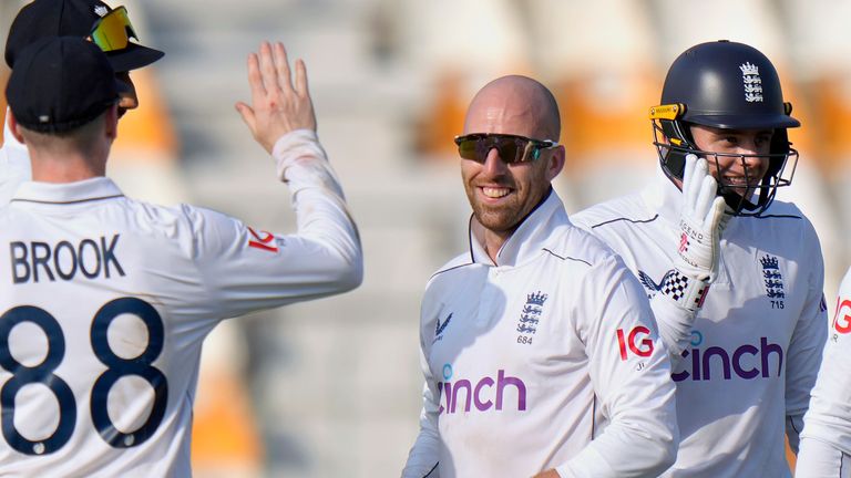 England's Jack Leach, center, celebrates with teammates after taking the wicket of Pakistan's Shan Masood during the first day of the first test cricket match between Pakistan and England, in Multan, Pakistan, Monday, Oct. 7, 2024. (AP Photo/Anjum Naveed)