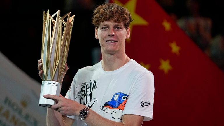 Jannik Sinner of Italy celebrates with his trophy after defeating Novak Djokovic of Serbia in the men's singles finals match for the Shanghai Masters tennis tournament at Qizhong Forest Sports City Tennis Center in Shanghai, China, Sunday, Oct. 13, 2024. (AP Photo/Andy Wong)