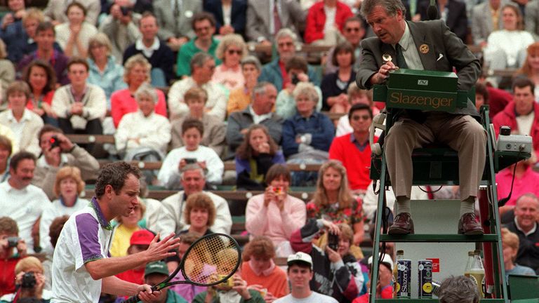 John McEnroe argues a line-call with umpire George Grime during his quarter-final against Guy Forget on Court One at Wimbledon.