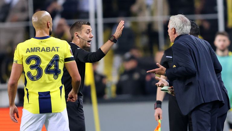 Jose Mourinho argues with referee Clement Turpin after his red card during Fenerbahce's Europa League match against Manchester United