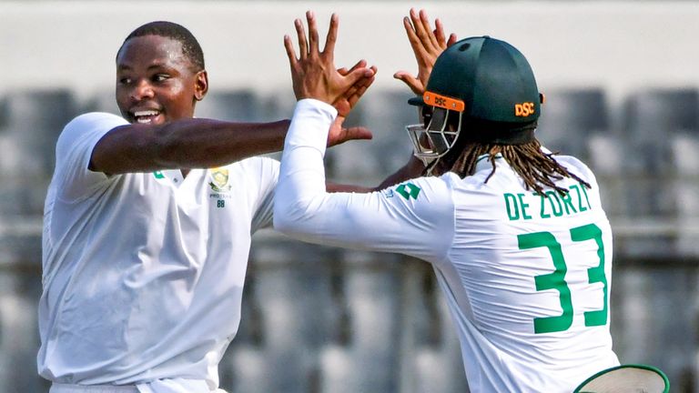 South Africa's Kagiso Rabada (C) celebrates with Tony de Zorzi (R) after taking the wicket of Bangladesh's Mominul Haque during the second day of the first Test cricket match between Bangladesh and South Africa at the Sher-e-Bangla National Cricket Stadium in Dhaka on October 22, 2024. (Photo by TANVIN TAMIM / AFP)