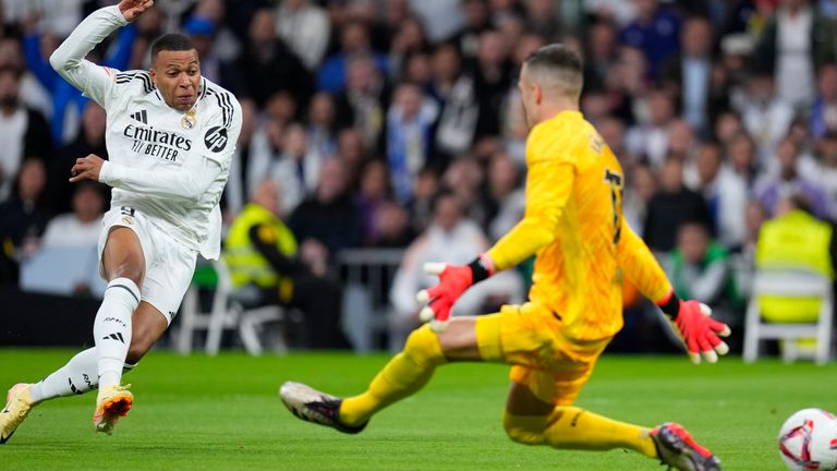 Real Madrid's Kylian Mbappe shoots on goal during a Spanish La Liga soccer match between Real Madrid and Barcelona at the Santiago Bernabeu stadium in Madrid, Spain, Saturday, Oct. 26, 2024. (AP Photo/Manu Fernandez)