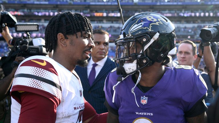 Washington Commanders quarterback Jayden Daniels, left, talks with Baltimore Ravens quarterback Lamar Jackson following an NFL football game Sunday, Oct. 13, 2024, in Baltimore. The Ravens won 30-23. (AP Photo/Nick Wass)