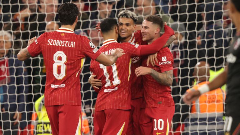 Liverpool player Alexis Mac Allister, center right, celebrates after scoring his side's opening goal during the Champions League football match between Liverpool and Bologna at Anfield Stadium in Liverpool, England, Wednesday, October 2, 2024. (AP Photo/ Ian Hodgson)