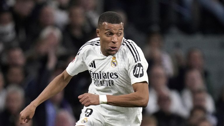 Real Madrid's Kylian Mbappe runs with the ball during a Spanish La Liga soccer match between Real Madrid and Barcelona at the Santiago Bernabeu stadium in Madrid, Spain, Saturday, Oct. 26, 2024. (AP Photo/Bernat Armangue)