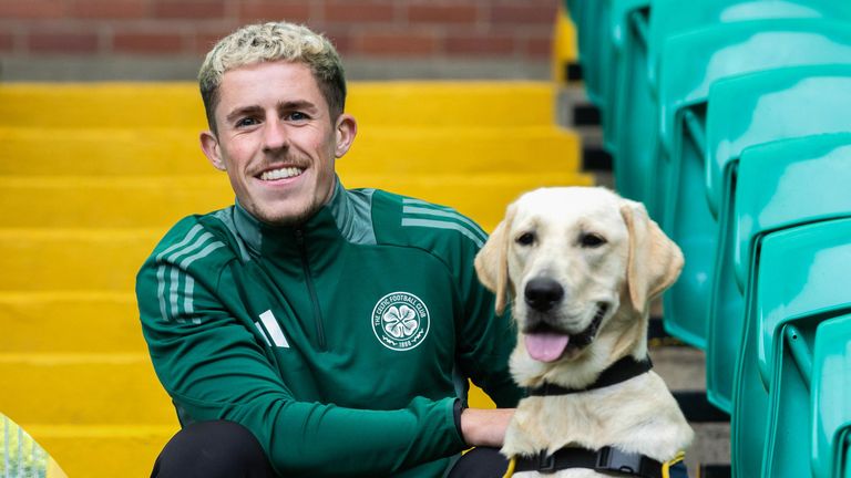 GLASGOW, SCOTLAND - OCTOBER 08: Luke McCowan with a guide dog during a Celtic & Guide Dogs Scotland October Puppy Appeal at Celtic Park, on October 08, 2024, in Glasgow, Scotland. (Photo By Craig Williamson / SNS Group)