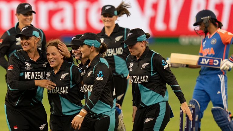 New Zealand team members congratulate Eden Carson, third from left, after she took the wicket of India's Smriti Mandhana during the ICC Women's T20 World Cup 2024 match between India and New Zealand at Dubai International Stadium, United Arab Emirates, Friday, Oct. 4, 2024. (AP Photo/Altaf Qadri)