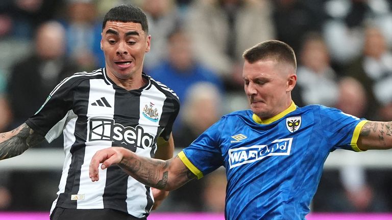 Newcastle United's Miguel Almiron and AFC Wimbledon's James Tilley battle for the ball 