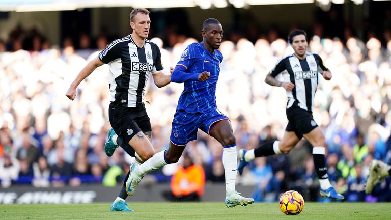 Chelsea's Nicolas Jackson and Newcastle United's Dan Burn in Premier League action