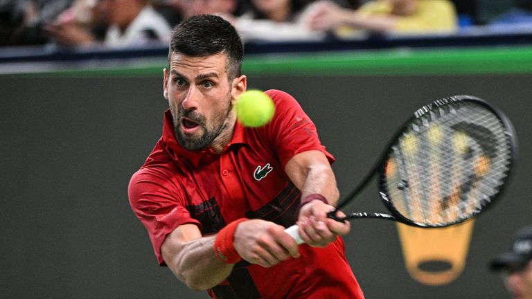 Serbia's Novak Djokovic hits a return to USA's Alex Michelsen during their men's singles match at the Shanghai Masters tennis tournament in Shanghai on October 5, 2024. (Photo by Hector RETAMAL / AFP)