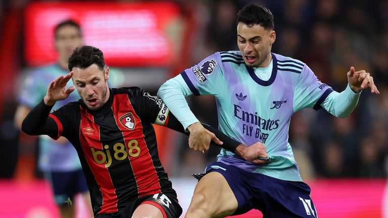 Adam Smith and Gabriel Martinelli battle for the ball