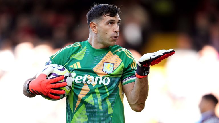 Emiliano Martinez celebrates after saving Andreas Pereira's penalty