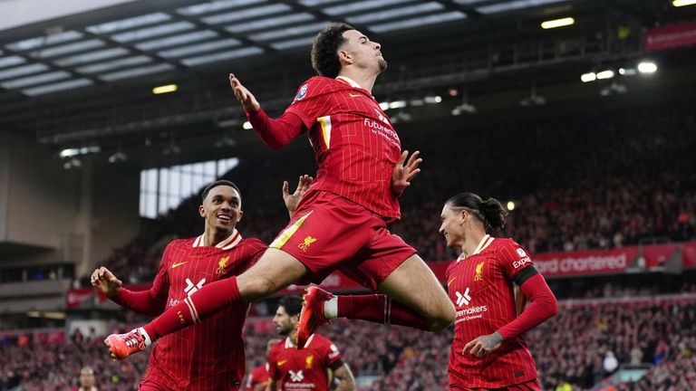 Curtis Jones leaps in celebration after restoring Liverpool's lead over Chelsea