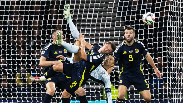 GLASGOW, SCOTLAND - OCTOBER 15: Portugal...'s Cristiano Ronaldo attempts an overhead kick under pressure from Scotland's Billy Gilmour during a UEFA Nations League Group A1 match between Scotland and Portugal at Hampden Park on October 15, 2024 in Glasgow. Scotland. (Photo by Craig Williamson / SNS Group)