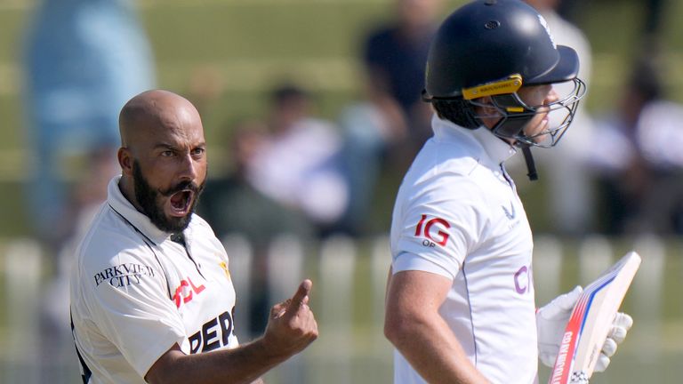 Pakistan's Sajid Khan (left) celebrates after taking the wicket of England's Ollie Pope (right) during the first day of the third test cricket match between Pakistan and England in Rawalpindi, Pakistan, Thursday, October 24, 2024 . (AP Photo/Anjum Naveed)