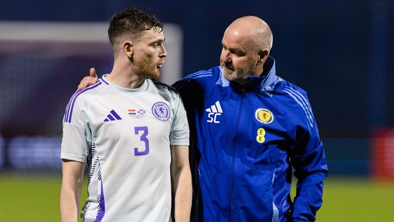 Andy Robertson is consoled by head coach Steve Clarke