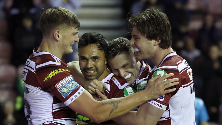 Wigan Warriors' Bevan French (second left) is congratulated by his team mates after scoring a try during the Betfred Super League, play off, semi-final match at The Brick Community Stadium, Wigan. Picture date: Saturday October 5, 2024.