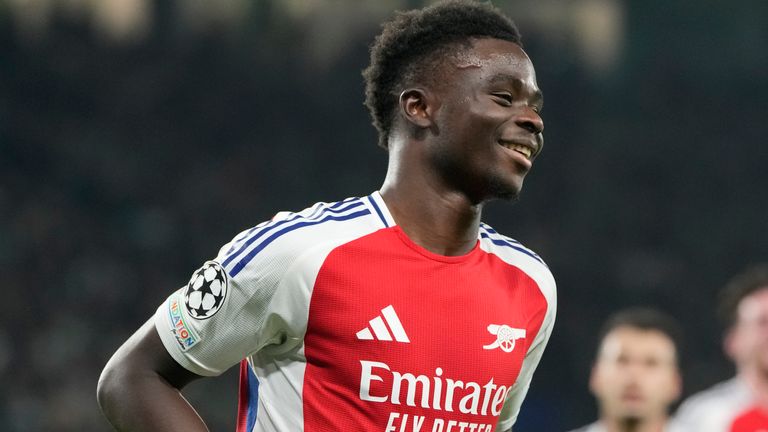 Arsenal's Bukayo Saka celebrates after scoring his side's 4th goal against Sporting during the Champions League opening phase soccer match at the Alvalade stadium in Lisbon, Tuesday, Nov. 26, 2024. (AP Photo/Armando Franca)