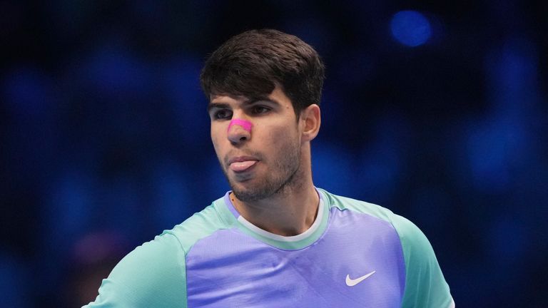 Spain's Carlos Alcaraz reacts during the singles tennis match of the ATP World Tour Finals against Germany's Alexander Zverev, at the Inalpi Arena, in Turin, Italy, Friday, Nov. 15, 2024. (AP Photo/Antonio Calanni)