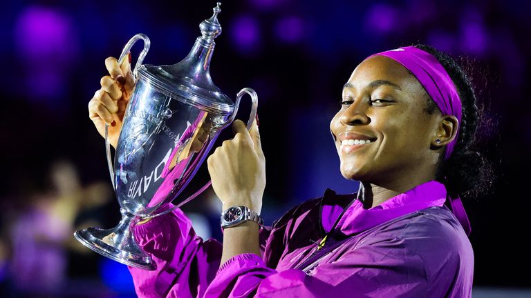 US' Coco Gauff celebrates with her winning trophy after defeating China's Zheng Qinwen in their women's singles final tennis match at the WTA Finals Championship in Riyadh on November 9, 2024. (Photo by Fayez NURELDINE / AFP)