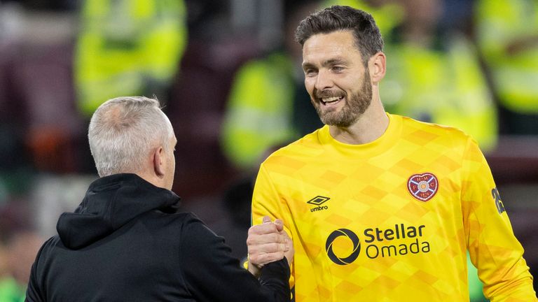 EDINBURGH , SCOTLAND - OCTOBER 24: Hearts head coach Neil Critchley (L) shakes hands with Hearts' Craig Gordon (R) at full time during a UEFA Conference League 2024/25 League Phase MD2 between Hearts and Omonia Nicosia at Tynecastle Park, on October 24, 2024, in Edinburgh, Scotland.  (Photo by Ross Parker / SNS Group)