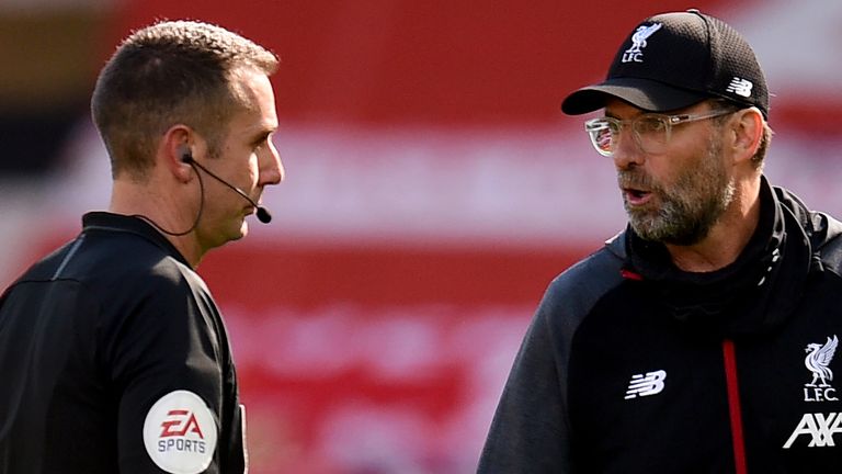 Liverpool's manager Jurgen Klopp (right) with match referee David Coote (centre) in July 2020