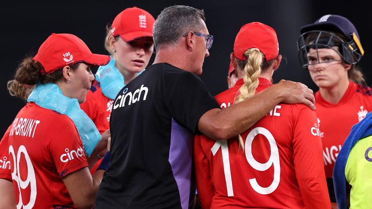 England head coach Jon Lewis consoles his players after the Women's T20 World Cup exit to West Indies