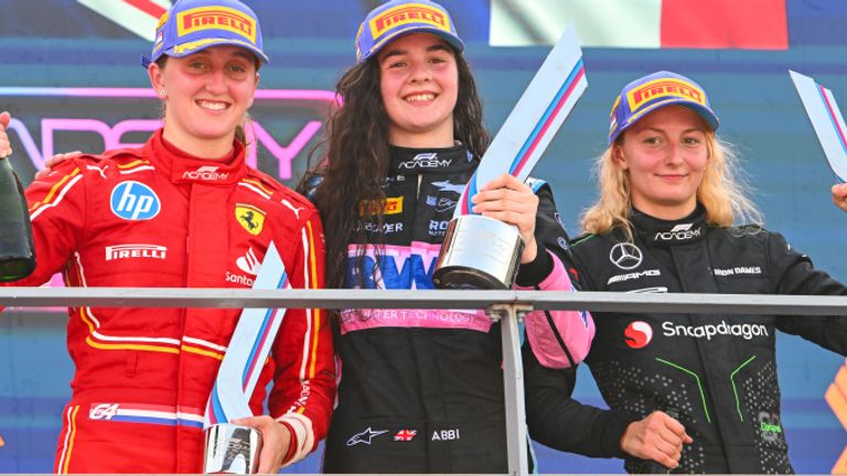 MARINA BAY STREET CIRCUIT, SINGAPORE - SEPTEMBER 22: Abbi Pulling (GBR, Rodin Motorsport), 1st position, Maya Weug (NLD, Prema Racing), 2nd position, and Doriane Pin (FRA, Prema Racing), 3rd position, on the podium during the Singapore at Marina Bay Street Circuit on September 22, 2024 in Marina Bay Street Circuit, Singapore. (Photo by Mark Sutton / Sutton Images)