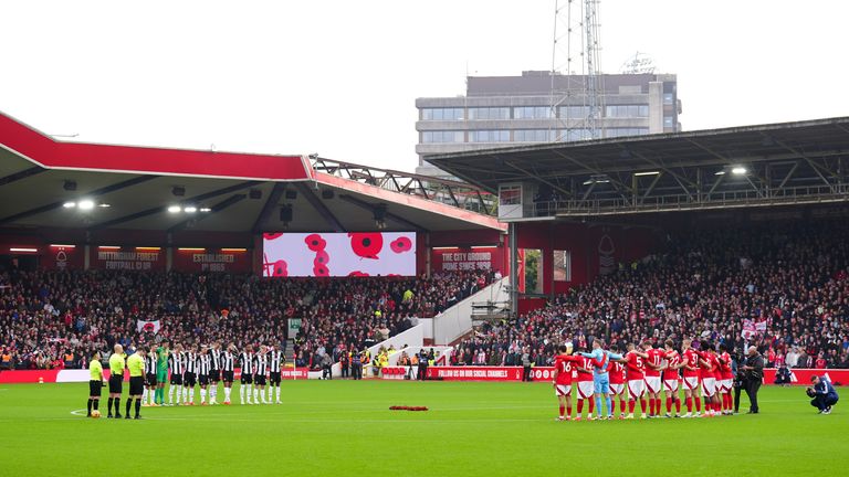 The players stand for a minute's silence to mark Remembrance Day