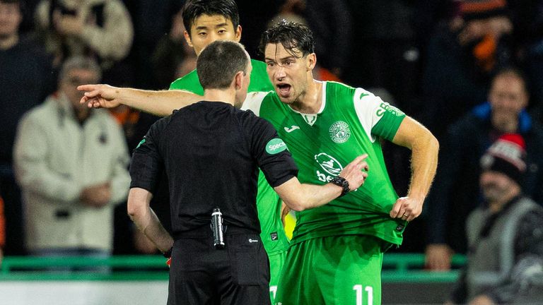 EDINBURGH, SCOTLAND - NOVEMBER 03: Hibernian's Joe Newell (R) argues with referee Colin Steven (L) after Mykola Kuharevich is sent off after consulting with VAR during a William Hill Premiership game between Hibernian and Dundee United at Easter Road, on November 03, 2024, in Edinburgh, Scotland. (Photo by Ross Parker / SNS Group)