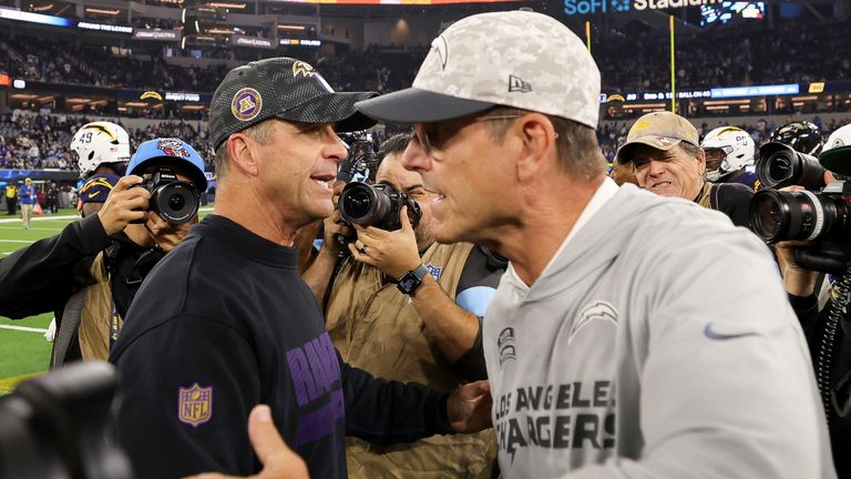 Baltimore Ravens Head Coach John Harbaugh, left, hugs Los Angeles Chargers head coach Jim Harbaugh 