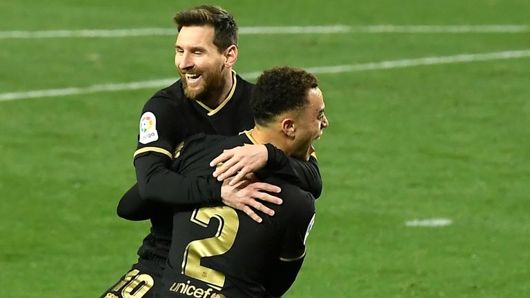 Barcelona's Sergino Dest celebrates with Barcelona's Lionel Messi scoring his side's 3rd goal during the Spanish La Liga soccer match between Real Sociedad and FC Barcelona at Reale Arena stadium in San Sebastian, Spain, Sunday, March. 21, 2021.