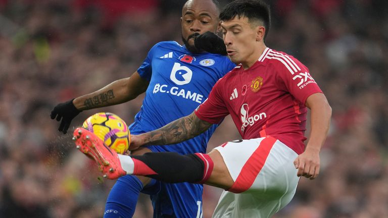 Lisandro Martinez competes for possession of the ball with Leicester's Jordan Ayew (AP Photo/Jon Super)