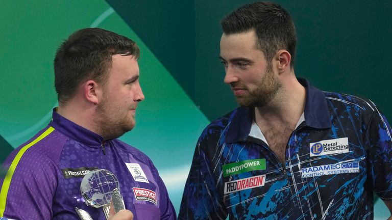 Luke Humphries, right, of England talks to Luke Littler of England after winning the final match at the World Darts Championship, in London, Wednesday, Jan. 3, 2024. (AP Photo/Kin Cheung) 