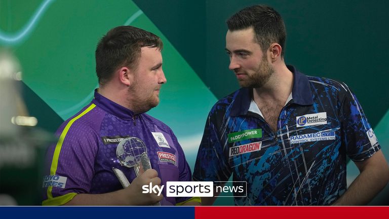 Luke Humphries, right, of England talks to Luke Littler of England after winning the final match at the World Darts Championship, in London, Wednesday, Jan. 3, 2024. (AP Photo/Kin Cheung)