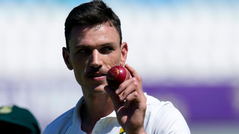 South Africa's Marco Jansen leaves the field as he holds the ball after taking seven wickets during the second day of the first Test cricket match between South Africa and Sri Lanka, at Kingsmead stadium in Durban, South Africa, Thursday, Nov. 28, 2024. (AP Photo/Themba Hadebe)