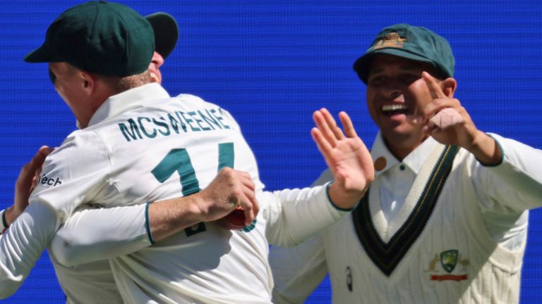 Australia's Nathan McSweeney hugs team-mate Marnus Labuschagne as they celebrate the wicket of India's Harshit Rana in the first Test (Associated Press)